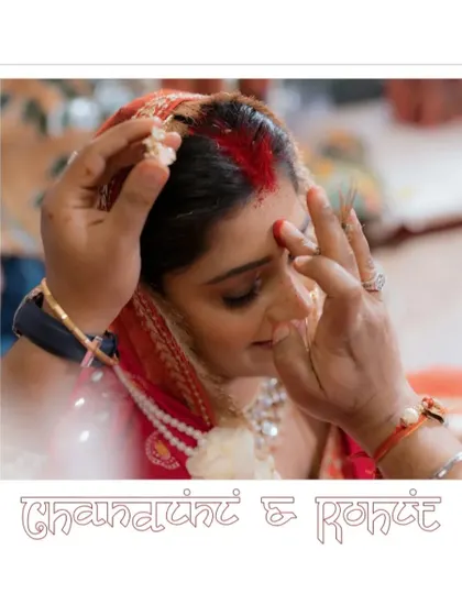 An intimate close-up of the sindoor ceremony. This frame, presented like a polaroid, focuses on the gentle and sacred application of the vermilion, marking the beginning of a new journey for Chandini and Rohit.