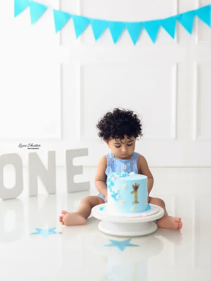Getting ready to dig in. A simple and clean setup for a cake smash session, with the focus entirely on the birthday boy and his delicious cake.