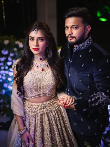 A final portrait of the couple from their engagement. Mahima's makeup is bold and beautiful, with a classic red lip that perfectly completes her glamorous look.