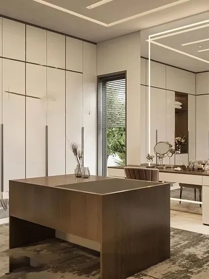 A spacious walk-in closet and dressing area with floor-to-ceiling wardrobes. The central island provides additional storage and a surface for accessories, while the vanity table features statement lighting.