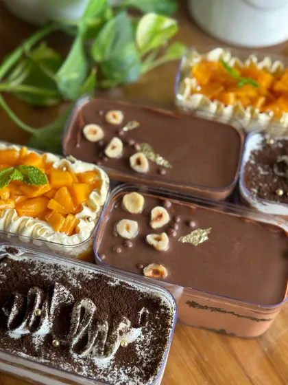 Our cake tubs are perfect for a personal indulgence. This image shows a variety of our flavors, including mango, tiramisu, and hazelnut chocolate, which were part of our 8th anniversary bake sale.