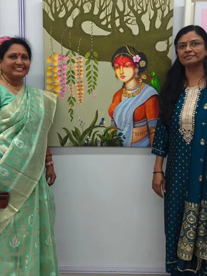 Two visitors admiring a beautiful painting by a fellow artist at our group exhibition. The gallery is filled with so much talent.
