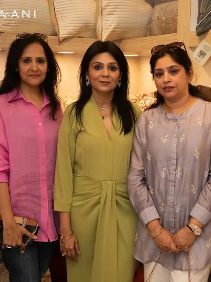 Introducing my latest soft furnishings amidst laughter and beautiful decor. This photo captures a moment with guests at my launch event, a reminder of why I love what I do.