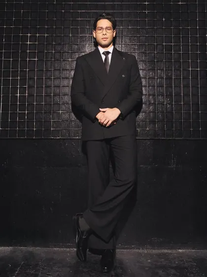 This full-length shot showcases the relaxed, wide-leg trousers of Siddhant's suit, a key detail that updates the traditional silhouette and adds a fashion-forward feel.