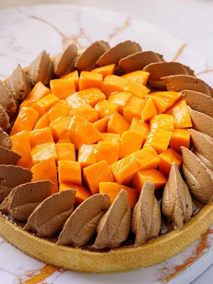 A mango and chocolate tart, showcasing a unique flavor combination. We use our photography to make creative dishes look as delicious as they taste.