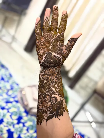 This design extends up the arm, with a mix of bold flowers and delicate leaves creating a beautiful flow.