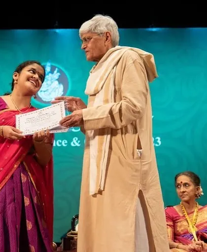 Another perspective of the award ceremony at the Music Academy, capturing the special interaction.