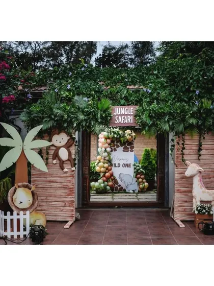 A full view of our jungle safari entrance, complete with a wooden arch, hanging monkey, and other friendly animal props to greet the party guests.
