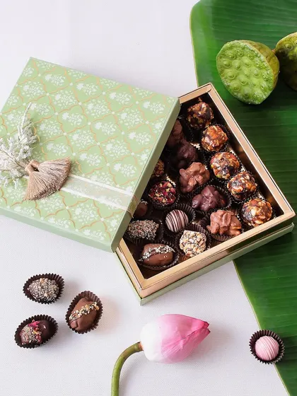 A beautiful triangular box filled with our best indulgent treats for Diwali: chocolate dates, truffles, clusters, and sugar-free date balls.