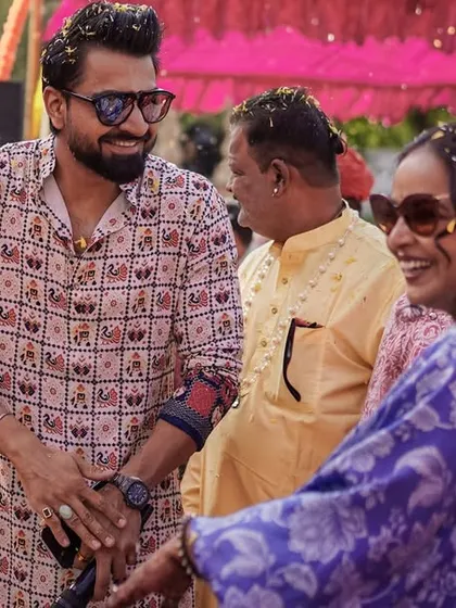 Sharing a laugh with guests during the Haldi festivities. These candid interactions are what make the event feel personal and special.