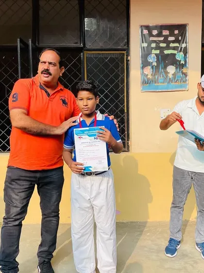 A proud moment for a young champion as he is honored for his performance in the national taekwondo championship.
