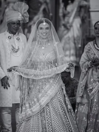A classic black and white portrait of the bride, Aayushi, on her wedding day. Her radiant smile and elegant attire capture the timeless beauty of the moment.