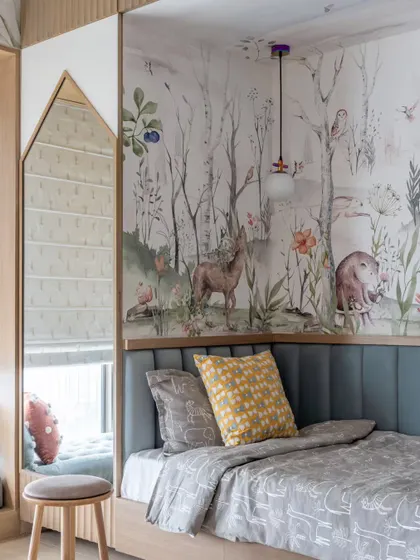 A magical bedroom we designed for our youngest clients at the Skyward Residence. The custom wallpaper creates an enchanted forest theme, and the house-shaped mirror nook is a whimsical touch.
