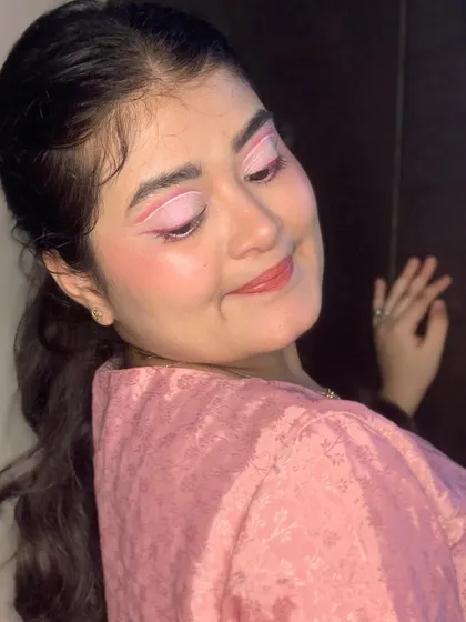 A smiling shot of the pink graphic liner look, showing how fun and wearable it can be.