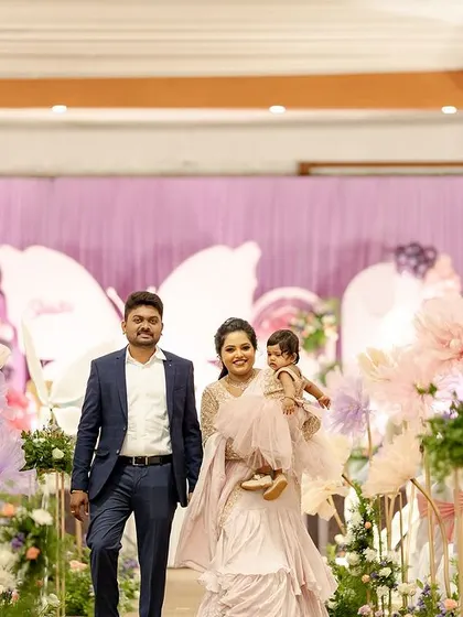 A family makes a grand entrance at their daughter's butterfly-themed first birthday party.