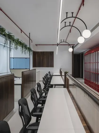 A symphony of cobalt whispers and crimson dreams. This office features a conference room that echoes the charm of a red telephone booth, creating a sanctuary where creativity dials up its brightest colors and every moment sparks with possibility.
