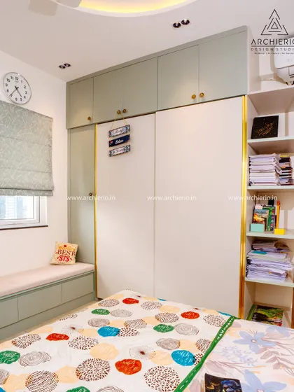 A practical and stylish teen's room with a two-tone wardrobe, a window seat with storage, and open shelving for books and decor.