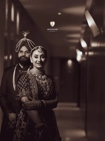 A classic black and white portrait of the couple in a hotel corridor, creating a timeless and elegant feel.