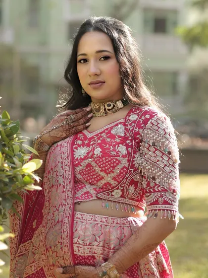 A stunning portrait of mom-to-be Dhwani. Her pink and red lehenga is so vibrant, and we kept the makeup fresh and radiant to match.