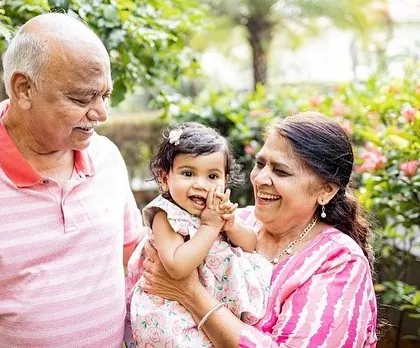 The pride and joy on grandparents' faces as they hold their grandchild. Including the whole family creates such precious memories for everyone to look back on.
