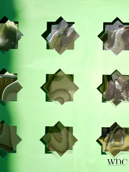 A close-up of the mirrored star cutouts on the sage green bar, reflecting the surrounding greenery and adding a touch of sparkle to the decor.