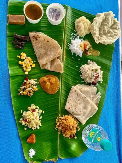 A delicious and wholesome meal served for a housewarming. It includes holige, rotis, multiple palyas, kosambari, and rice, ensuring guests are fully satisfied.