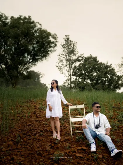 A stylish, relaxed portrait of the couple in a natural, rustic setting, showcasing a modern approach to pre-wedding photography.