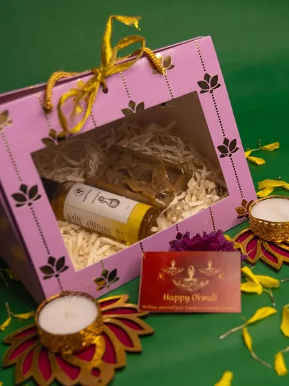 A simple and elegant Diwali hamper featuring our natural Abhyanga oil, beautifully packed in a window box with a festive greeting card and diyas.