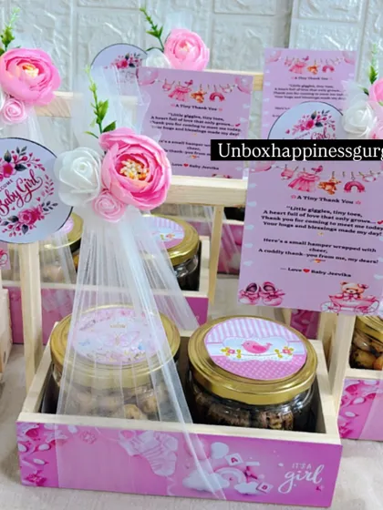 A close-up view of the pink announcement baskets, showing the sweet "A Tiny Thank You" message from the baby.