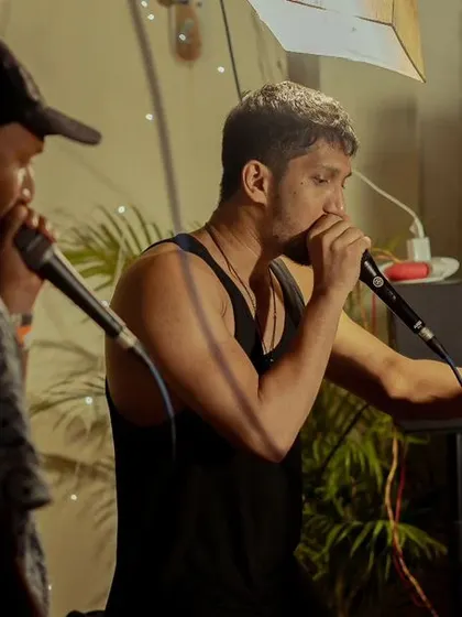 A focused moment during a beatbox duo performance. You can see the concentration required to sync up rhythms and sounds with another artist in real time.