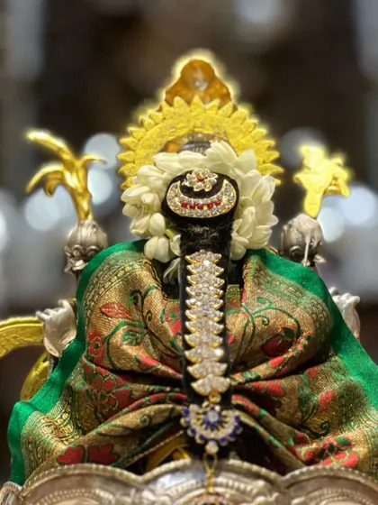 A close-up of the deity's hair decoration, or 'jade'. This is an important part of the alankara, and I share simple methods to create beautiful traditional hairstyles for the idol.