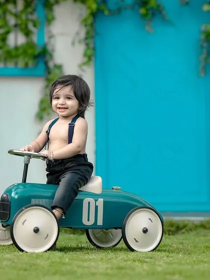 A happy little boy on his favorite ride-on car. The smile on his face says it all!