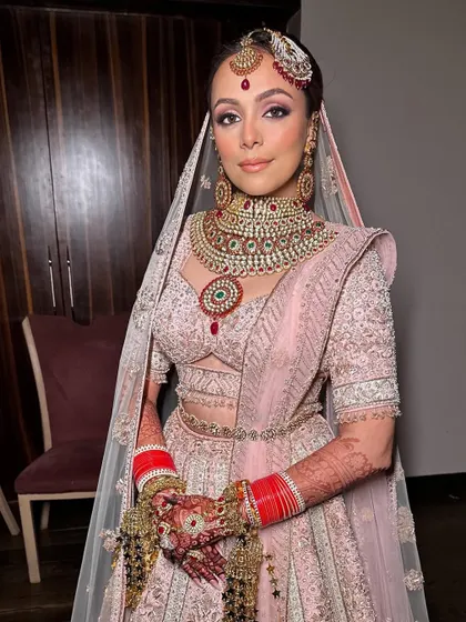 A super dewy and soft bridal makeup look for my bride Ridhima. I accentuated her eyes and focused on creating a lit-from-within glow to complement her pastel pink lehenga.