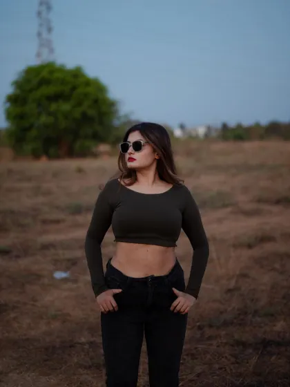 A duplicate of image 493, this portrait captures a confident and moody look in an open field at dusk.