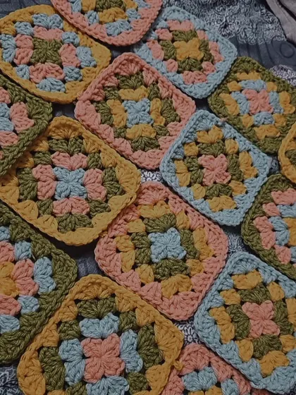 Officially 100 granny squares completed for a project. This is a satisfying look at all the colorful squares piled up, ready to be joined together.