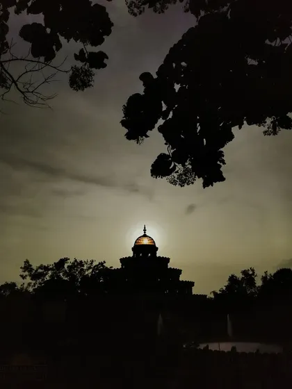 The golden dome of the Vishalakshi Mantap glows as the sun sets behind it. The campus offers countless picture-perfect moments where divinity and nature meet.