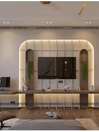 This bedroom features a beautifully crafted TV unit with a curved, upholstered backdrop. An extended floating desk provides a spacious and elegant workspace, seamlessly integrated into the room's design.