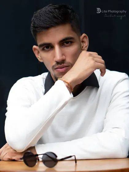 A classic seated portrait of Karan Lakhanpal. The direct gaze and simple composition make for a strong and confident headshot.
