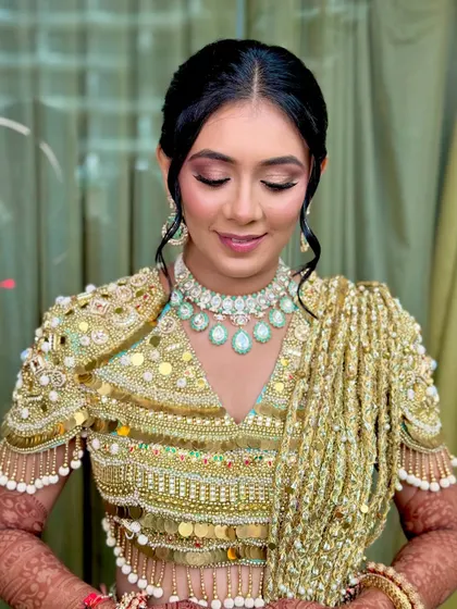 A close-up of the Haldi makeup, with eyes closed to showcase the beautiful pink and gold eyeshadow.