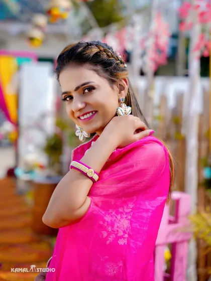 A beautiful portrait of a guest in a vibrant pink suit, enjoying the Haldi festivities.
