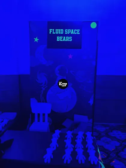 An interactive station for 'Fluid Space Bears', where kids could create their own cosmic art in a room lit entirely by blacklights.