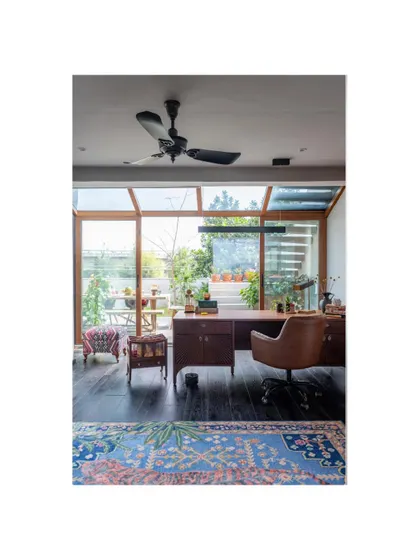 A magazine feature of the study in the Dhaka home. The space is designed to be both functional and beautiful, with a large desk overlooking the garden.