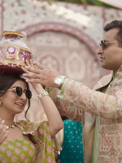 A playful moment during the Janya ceremony where a decorated pot is placed on the bride's head.