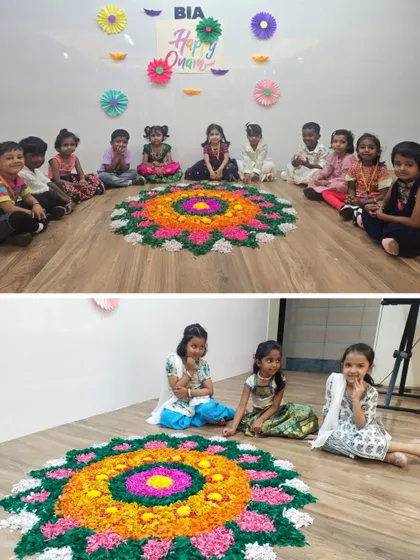 Students sit in a circle around a vibrant Pookalam they helped create, celebrating the festival of Onam with a sense of community and artistic achievement.