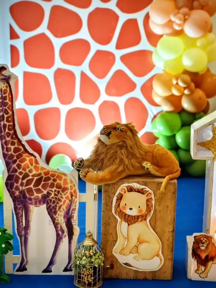 A close-up of the props for the safari theme, including a plush lion and a light-up number '1'.