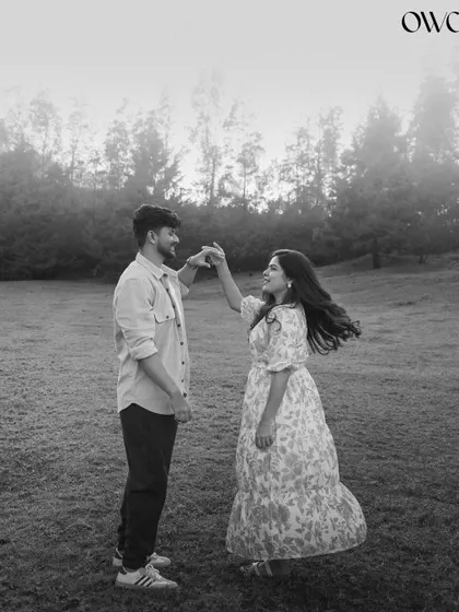 A classic black and white photo of a couple dancing in a misty field, full of romance and timeless charm.