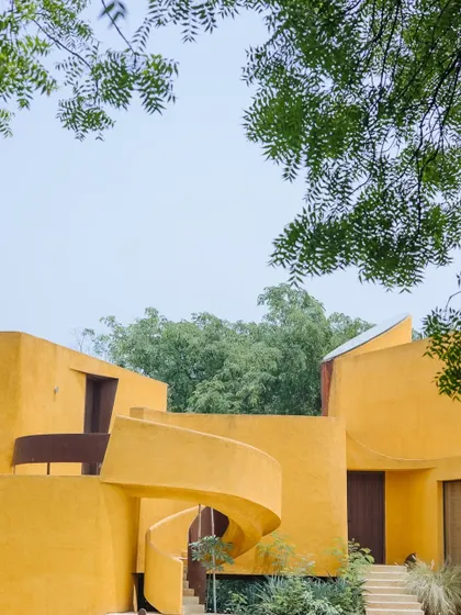 Our architecture is a conversation between form and nature. The iconic ochre spiral staircase is not just a feature but an experience, leading you through spaces that are designed to feel both expansive and deeply personal.