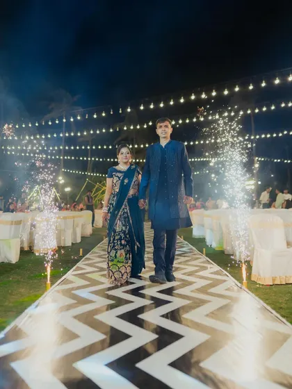 The couple's grand entrance down the modern chevron aisle, a perfect start to a night of dancing and celebration at their Sangeet.