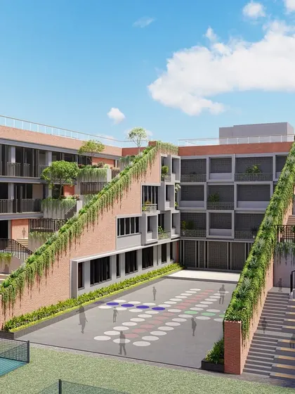 Another view of the school in Chhattisgarh, highlighting the central courtyard and the green, cascading steps. This space is designed to be the heart of the school, a place for interaction and play.