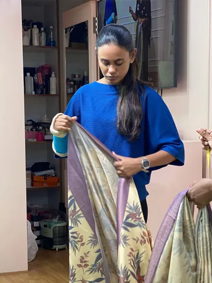 Another student perfecting her pleating technique. We work with various saree materials so they are prepared for any client request.